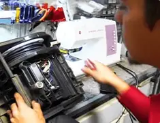 Vacuum repair technician servicing internal components on a workbench in El Paso, TX